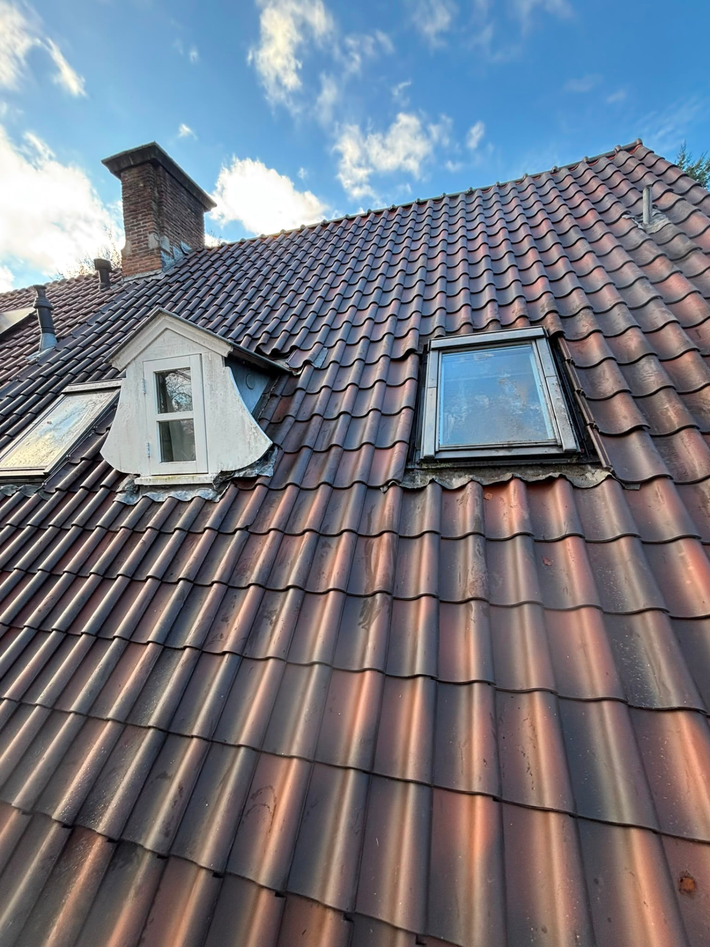 Pannendak met dakkapel, dakraam en gemetselde schoorsteen